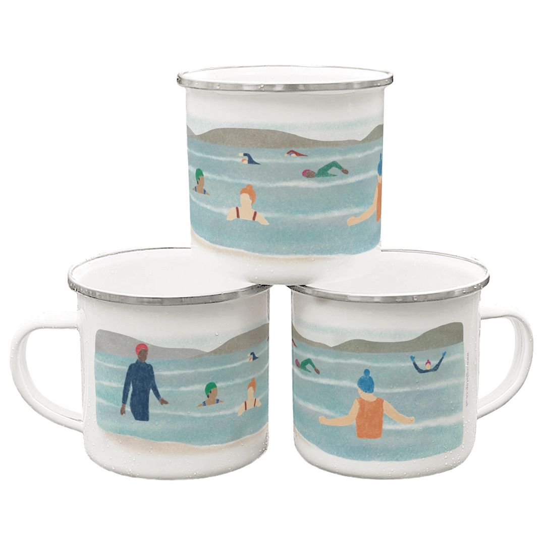 White enamel mug with an illustration of a group of wild swimmers enjoying a bracing dip!