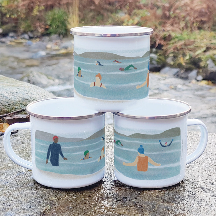 White enamel mug with an illustration of a group of wild swimmers enjoying a bracing dip!