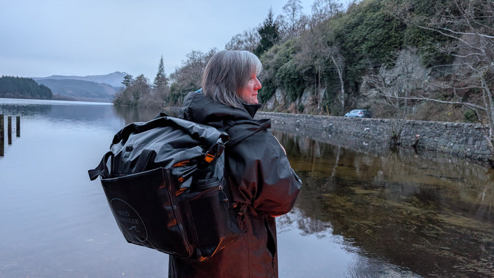 Woman carrying the Wild Changer Backpack style by a scottish loch