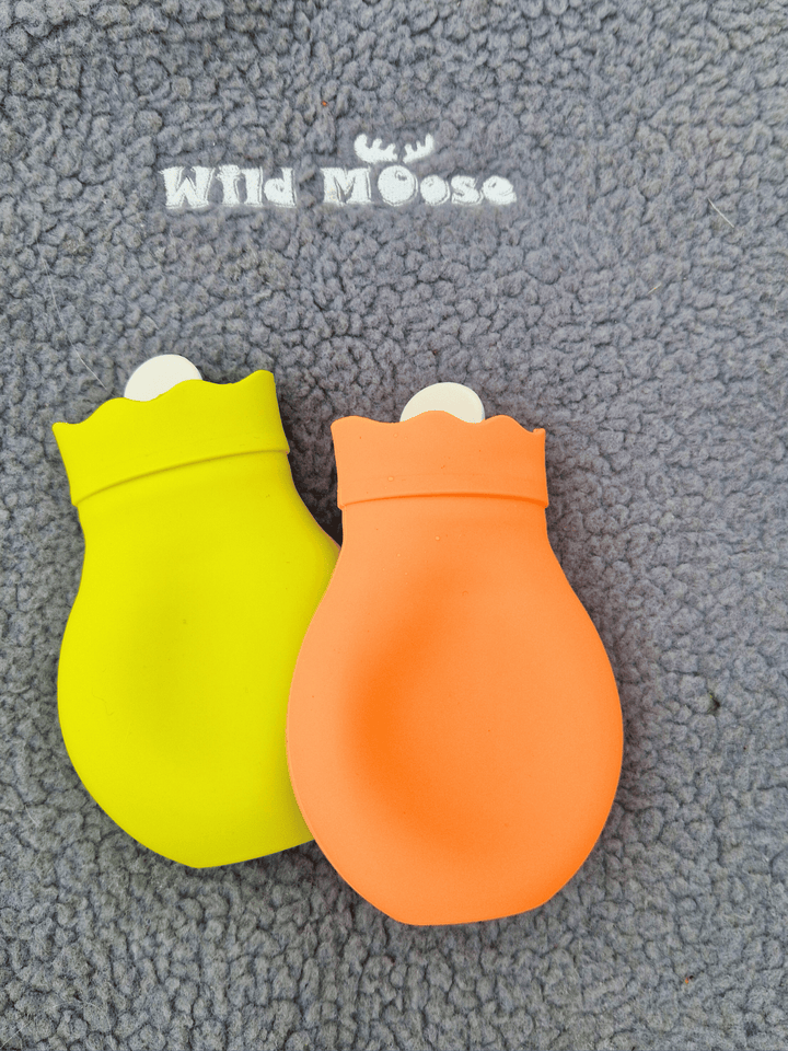 brightly coloured mini hot water bottles in orange and lime green on a grey fleece backdrop with the Wild Moose logo above