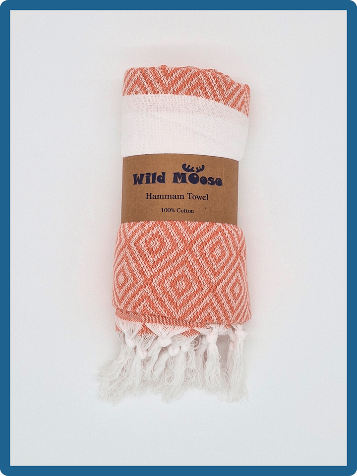 Lightweight cotton hammam towel from Wild Moose in starfish orange