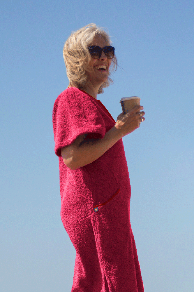 Short pink Kiss dress by So English, shown in a beachwear setting with a relaxed, stylish fit and vibrant color.