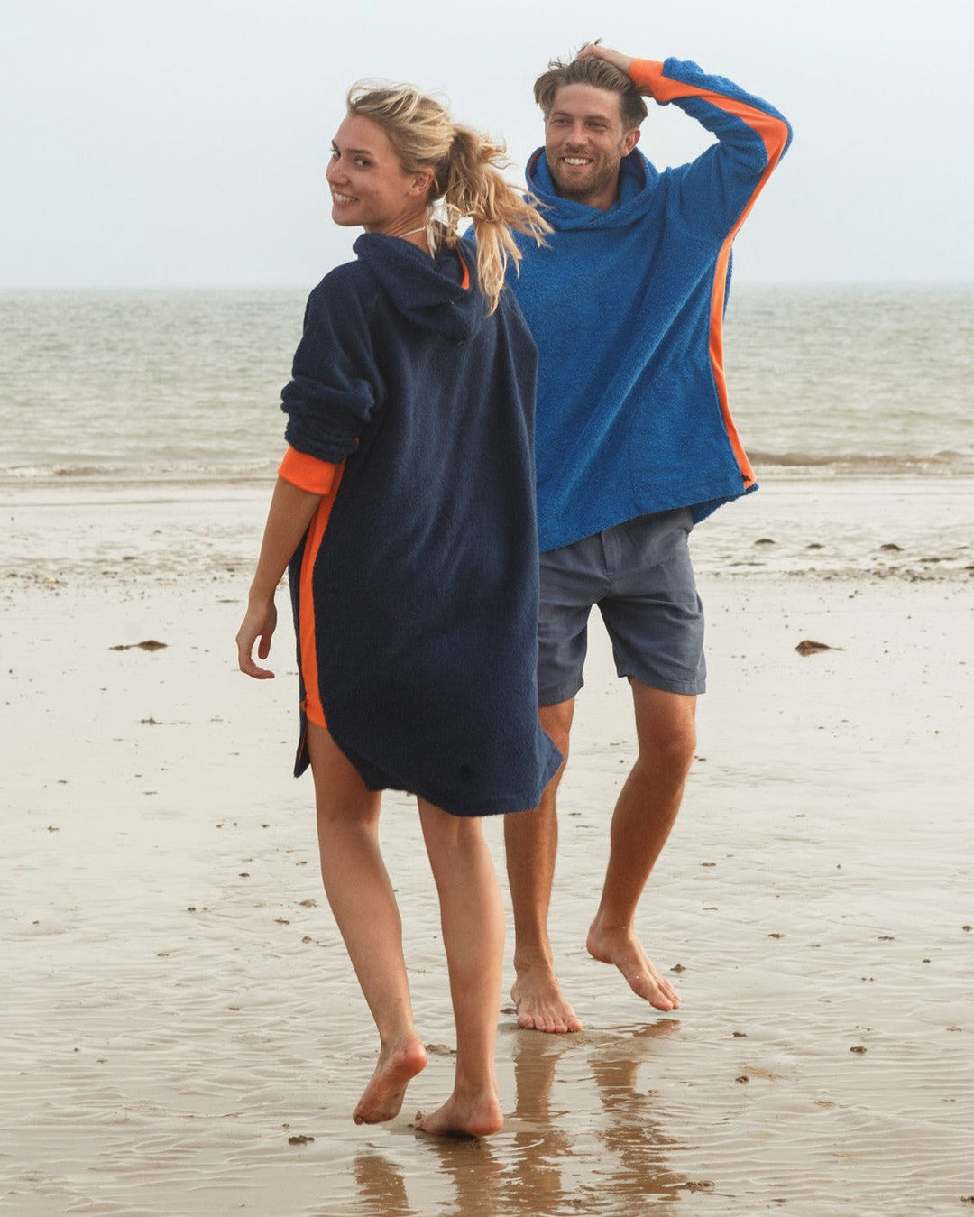Navy and orange long hoodie by So English featuring casual beachwear style, displayed in a lifestyle setting.