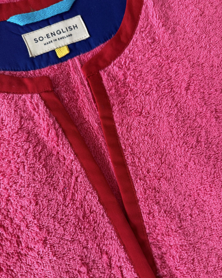 So English pink Kiss dress with short length and detailed neckline, perfect for beachwear or casual summer outings.