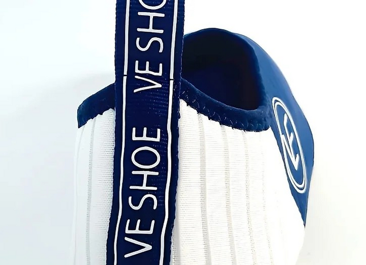 Flat shot of the back of a pair of VE Shoe navy and white water shoes