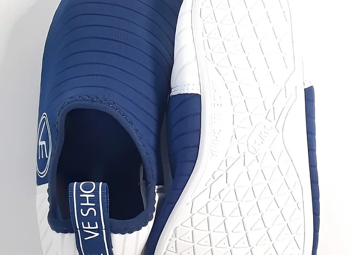 Flat shote of the white sole of a pair of VE Shoe navy and white water shoes