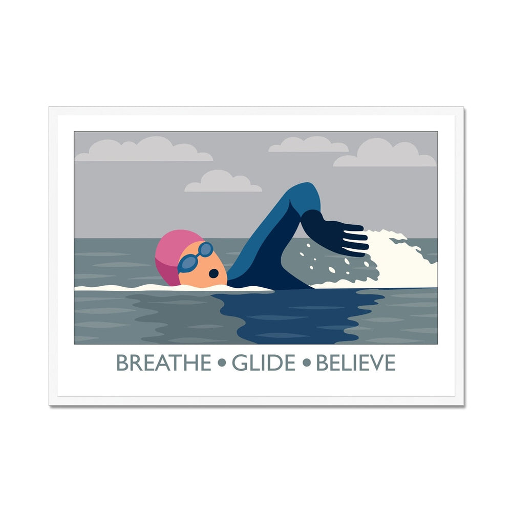 Framed wild swimming art print in white frame showing open water swimmer mid-stroke titled Breathe Glide Believe