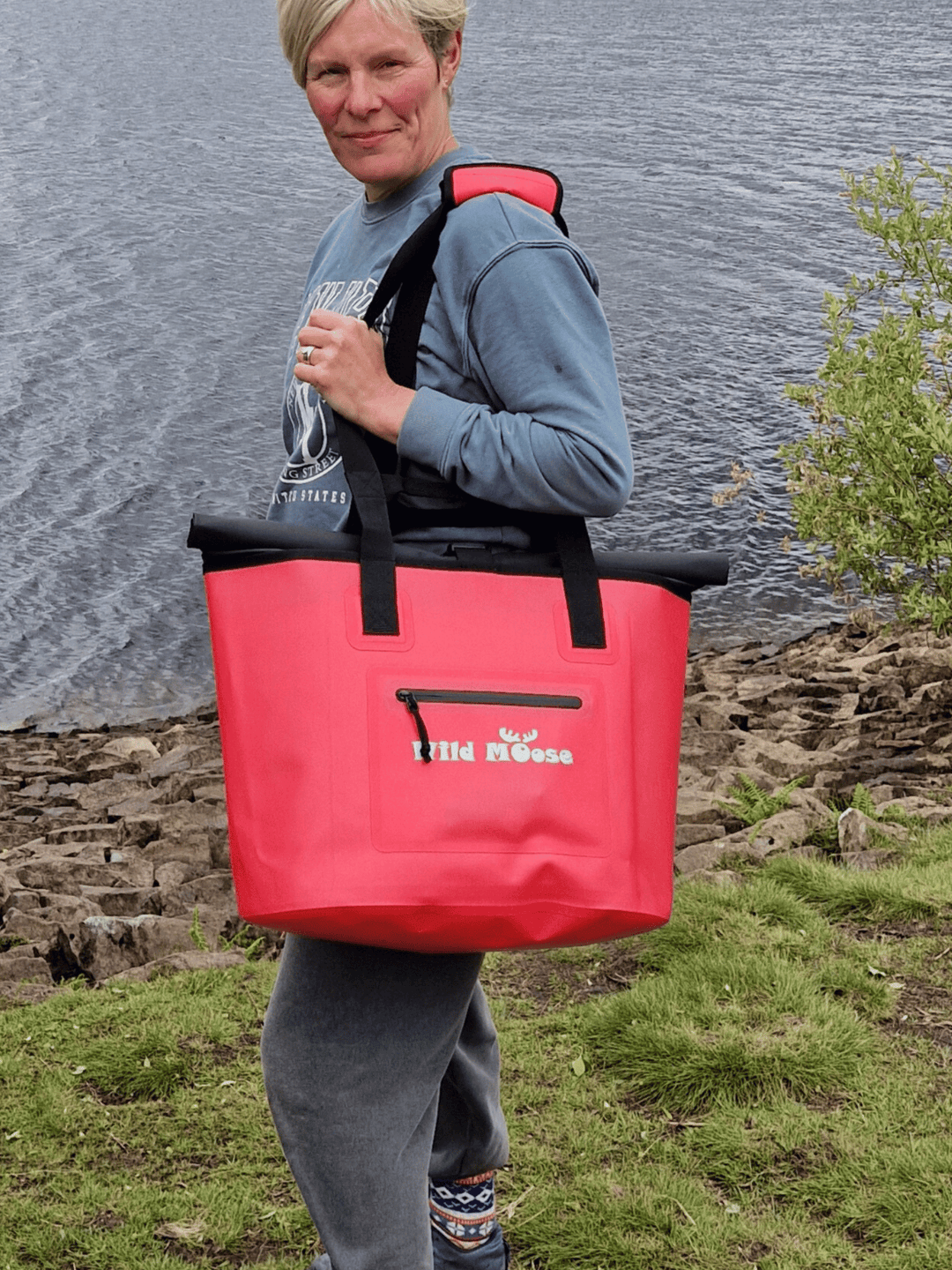 Waterproof tote bag with comfortable padded shoulder strap and grab handles for easy carrying to your swim spot