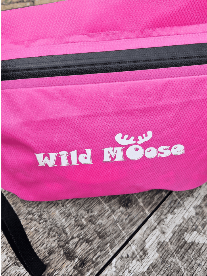 Pink bag with 'Wild Moose' logo on a wooden surface