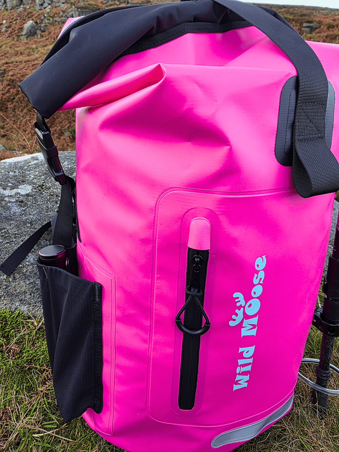 Pink waterproof bag with 'Wild Moose' branding on a natural background