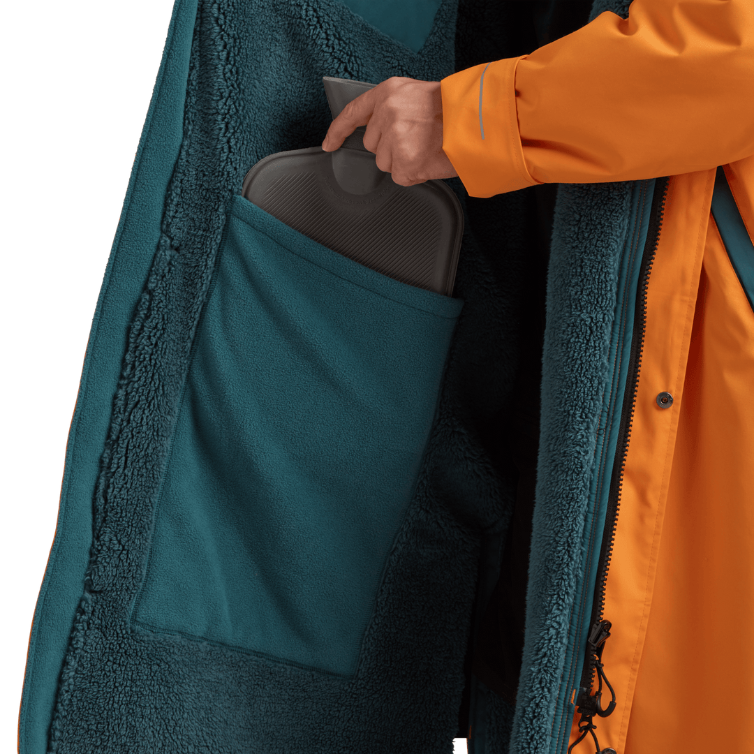 Large inside stash pocket, big enough to hold a hot water bottle, on Red Alter Evo men’s long sleeve waterproof changing robe in Bitter Orange.