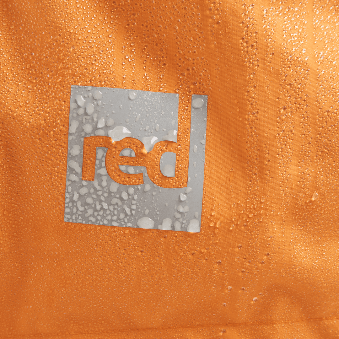 Red Equipment logo detail on Alter Evo men’s long sleeve waterproof changing robe in Bitter Orange.