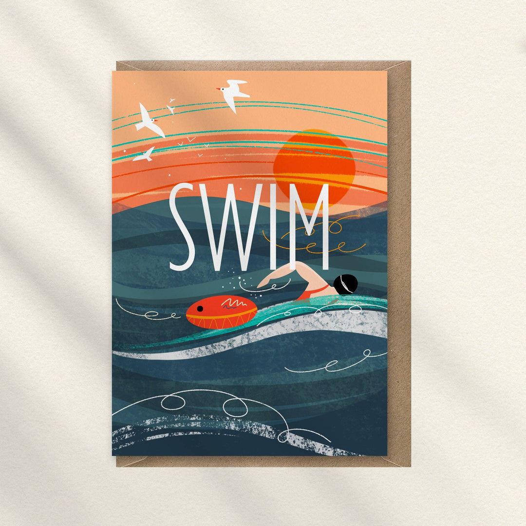 Swim wild swimming greeting card by Onneke featuring a lone swimmer in the sea at sunrise with a bright orange tow float.