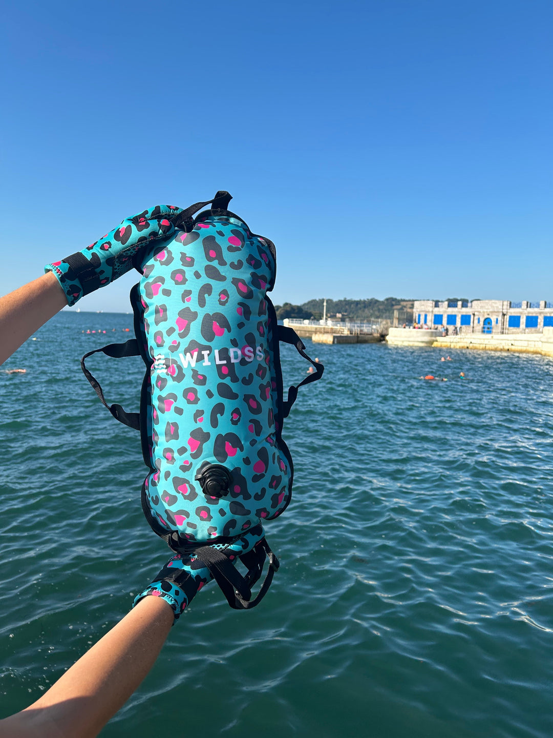 Close-up of blue leopard print tow float with built-in thermometer for open water swimming.