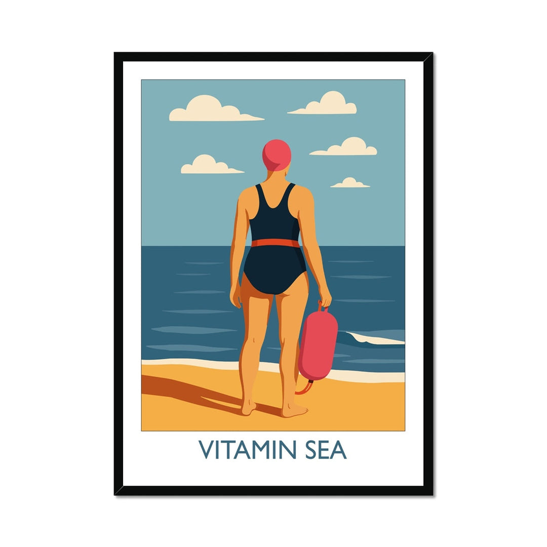 Framed wild swimming art print in black frame featuring a swimmer holding a tow float at the shoreline, titled Vitamin Sea