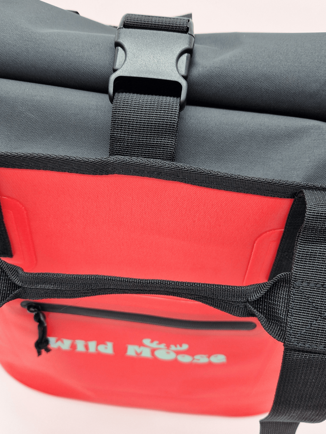 Close up product shot of a coral coloured Wild Moose tote bag with a splash-proof zip pocket on front for small items