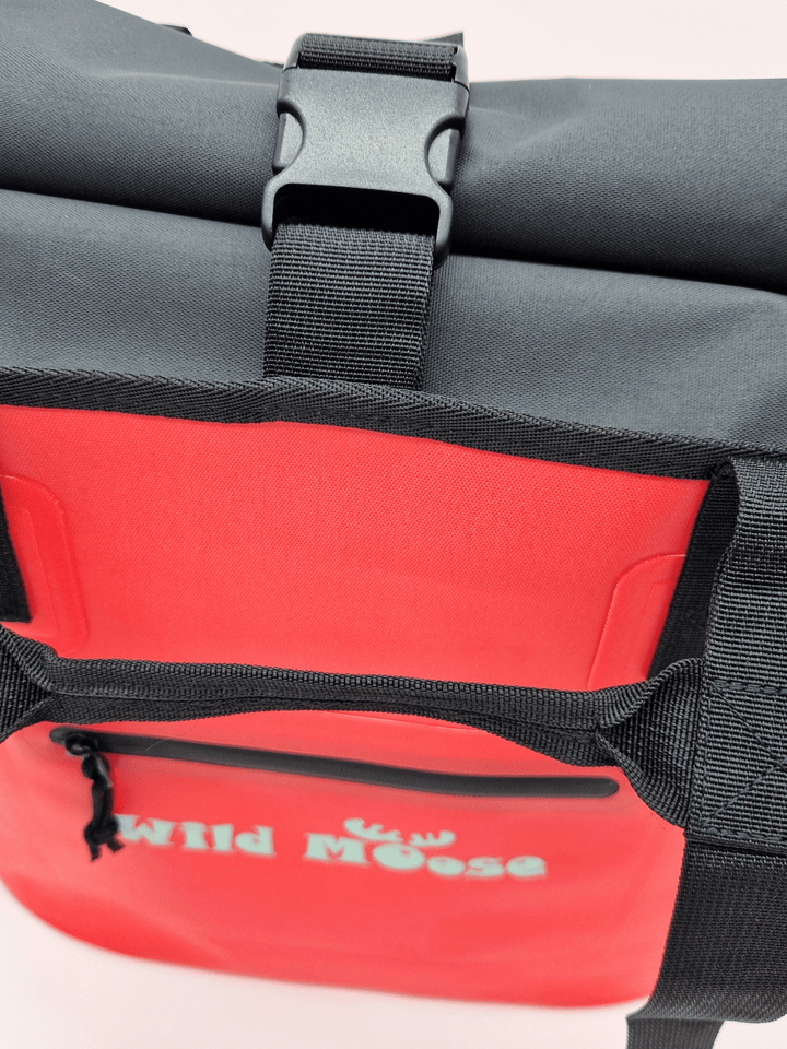 Close up product shot of a coral coloured Wild Moose tote bag with a splash-proof zip pocket on front for small items