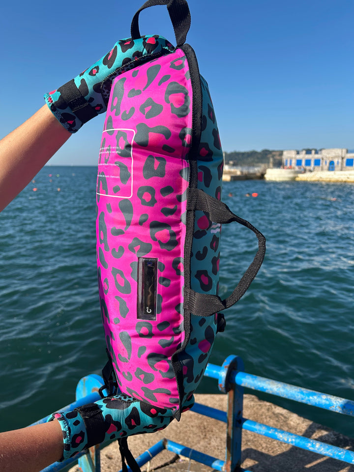 Close up of the Wild Swimming Socks dual print blue/pink leopard tow float with built-in thermometer for open water swimming.