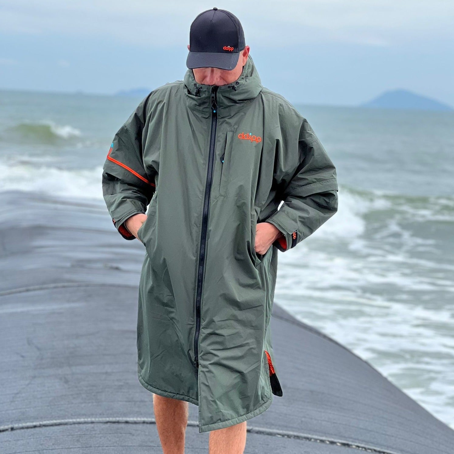 A model wearing the ddipp Sea Monster Robe on a beach