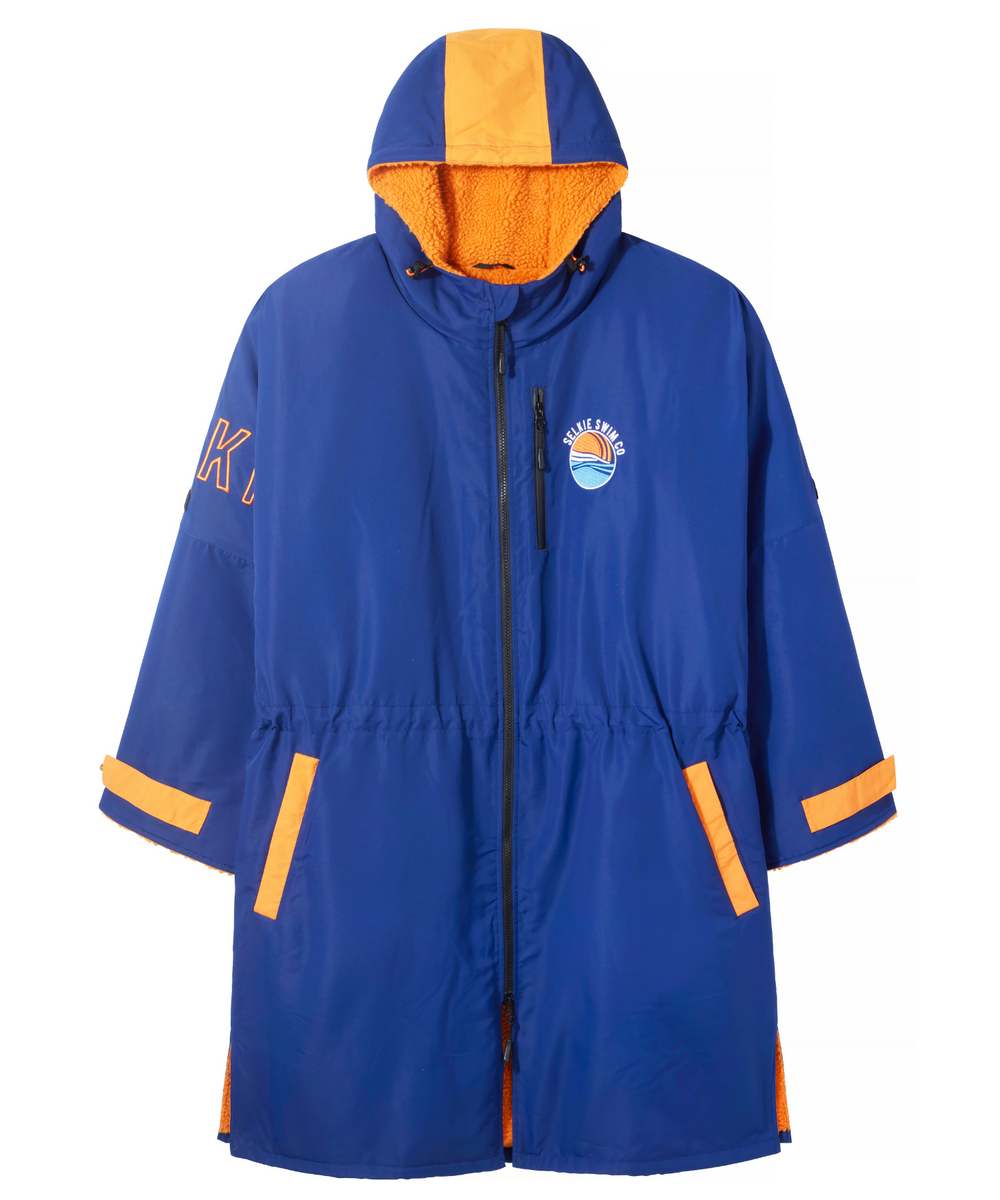 Front view of Selkie waterproof changing robe in navy with orange sherpa lining.